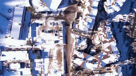 Birds-Eye-Aerial-View-of-Palisades-Ski-Resort-Buildings,-Lake-Tahoe,-California-USA-on-Sunny-WInter-Day