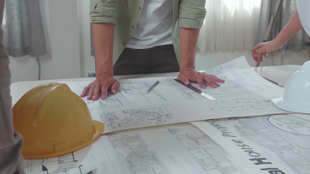 Close Up Of Group Of Asian Engineers Discuss About Building Construction At The Office