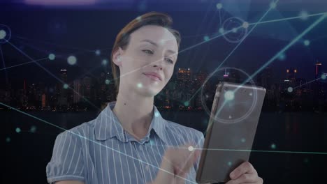 Animation-of-caucasian-businesswoman-using-tablet-and-network-of-connections-over-cityscape