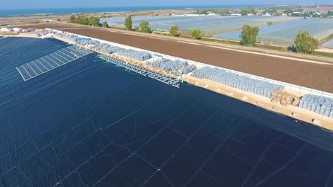 drone tracking shot right to reveal the scope of a massive solar power construction project. daytime.
