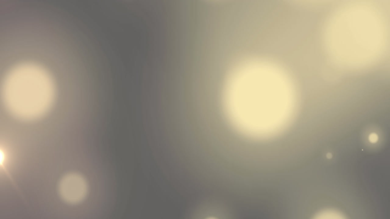 Animation of bokeh white light spots moving over grey background