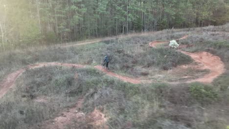 man biking around curve at mountain bike park