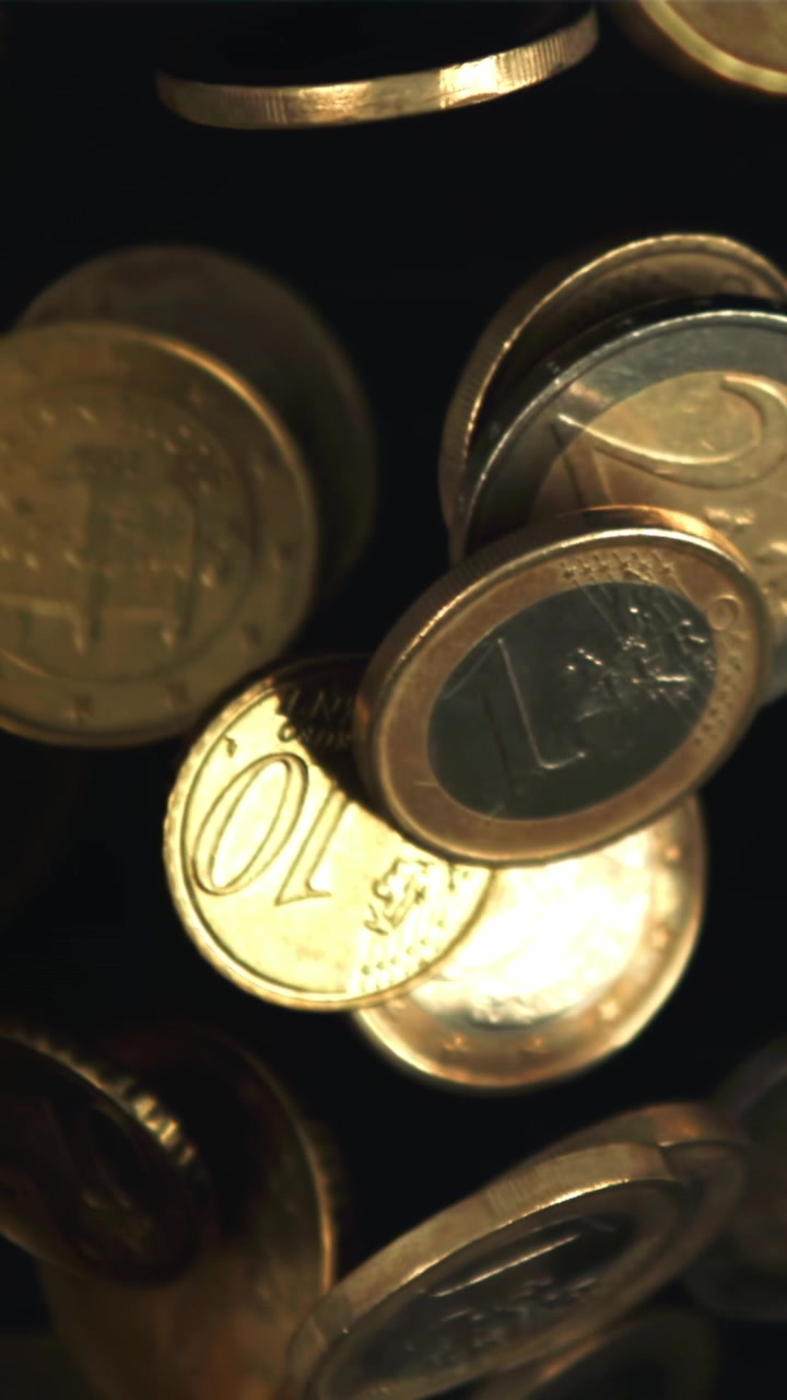 Golden Euro Coins Falling and Floating in Slow Motion on Black Background
