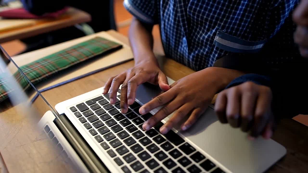 Schoolkids using laptop in classroom 4k