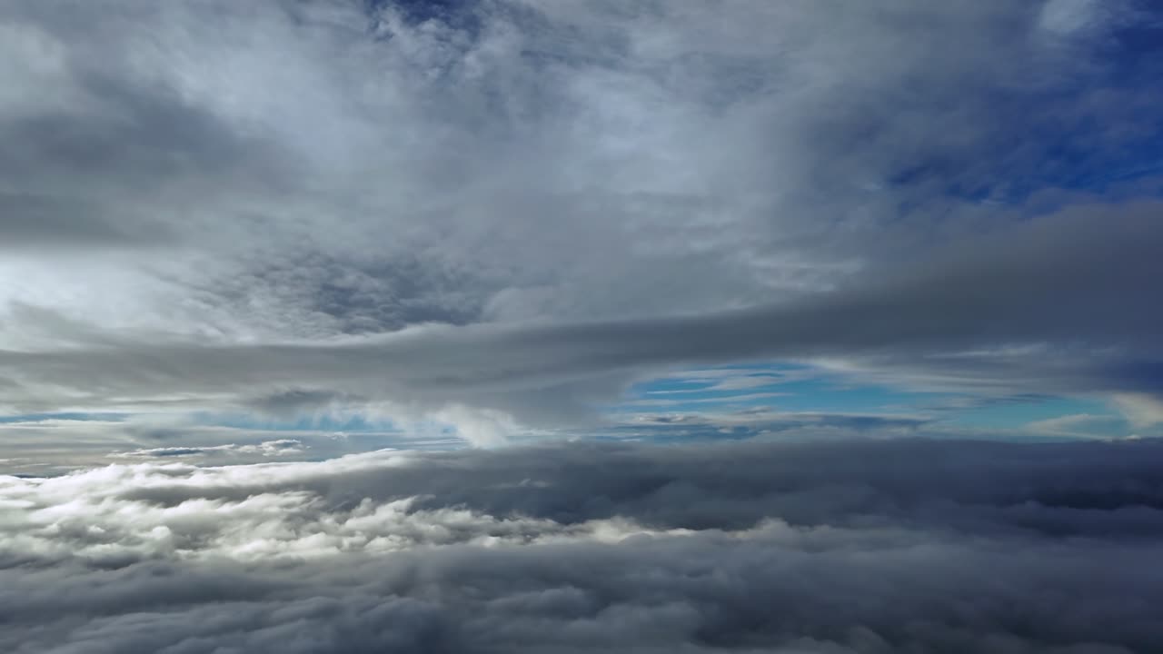 A Pilot’s point of view POV from a jet cockpit flying peacefully between layers of ethereal clouds illuminated by the sunrise light in a deep blue sky. ultra-realistic shot