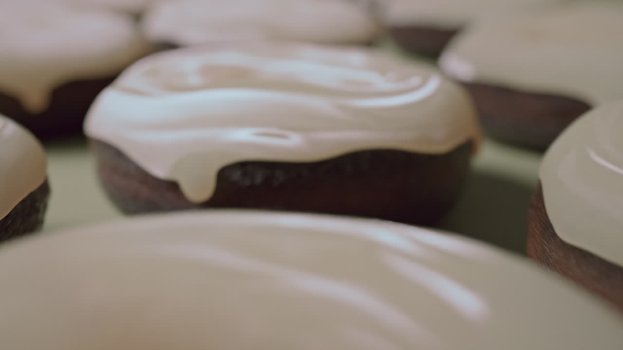 White glaze donuts on a light green background