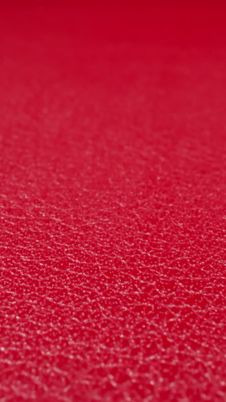 Abstract pattern of wrinkles on red cow leather surface as background macro view. Sewing material for different items crafting. Design and decor