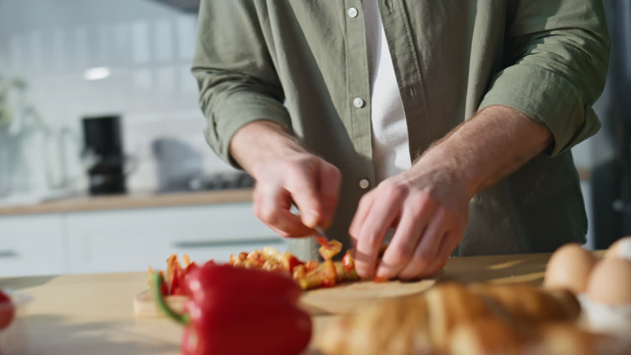 Man hands preparing vegetables for vegetarian salad at modern kitchen closeup