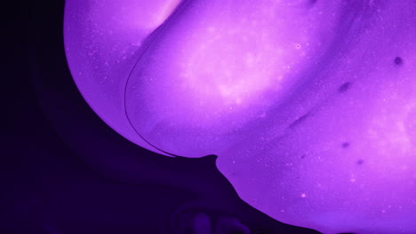 organic purple bulbous abstract art fluid effect moving expanding into black space