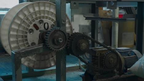 industrial machine with gears, belts, and motor