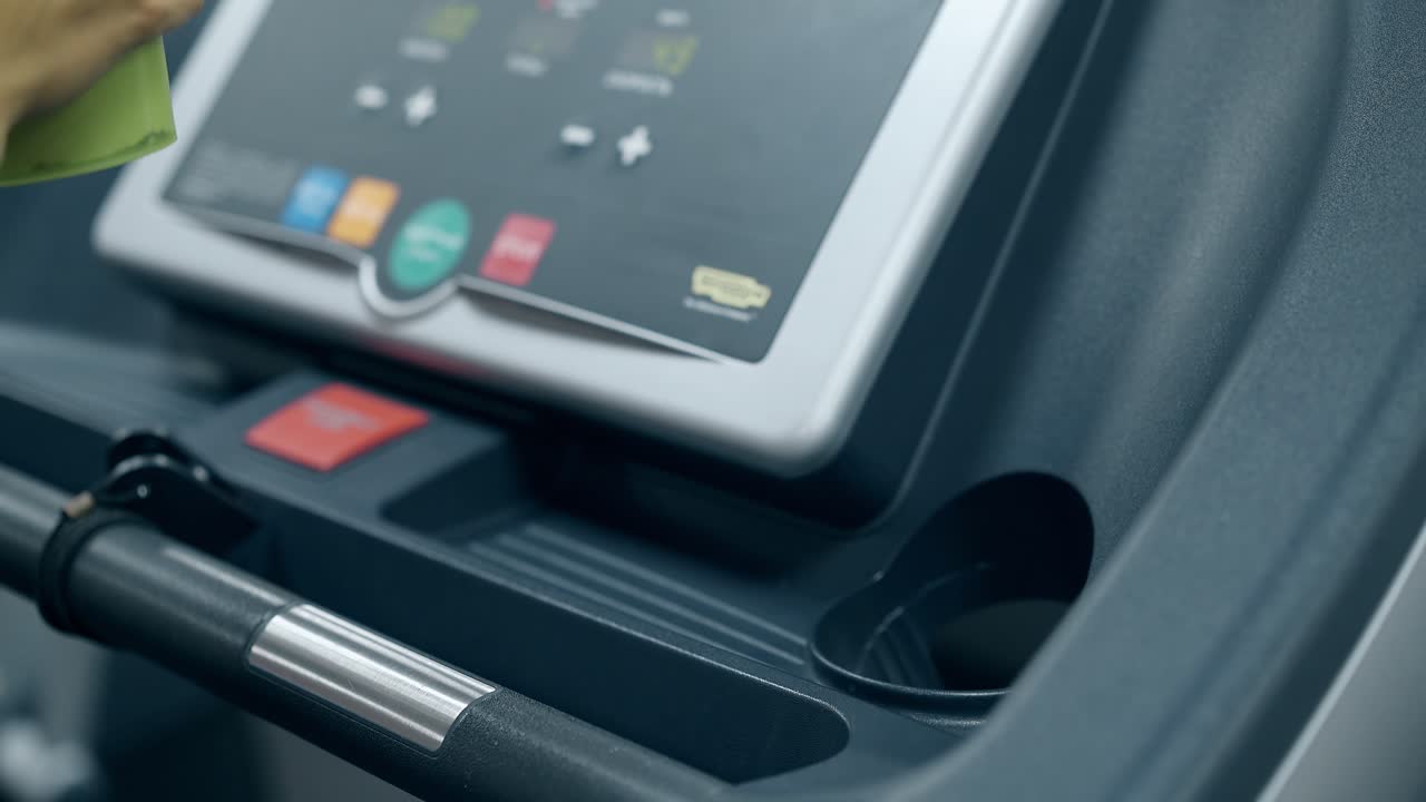 slow motion girl hand takes green bottle from treadmill