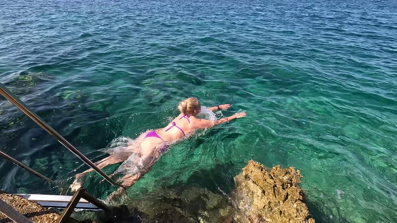 Beautiful Woman in Bikini Swims and Snorkel Adriatic Sea Underwater View. Radmanand Petrcane Beach in Zadar, Dalmatia Croatia. Petrcane Village,Travel Concept