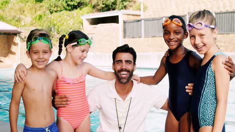 Portrait-of-male-trainer-with-his-students