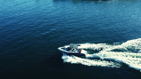 Wakeboarding-boat-at-the-lake,-panning-shot