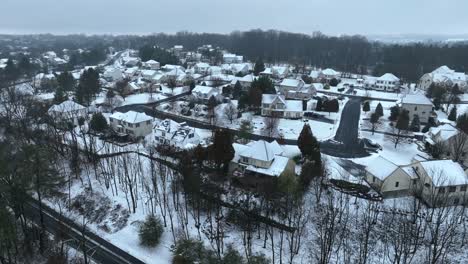 american neighborhood with snowy roofs at winter day in pennsylvania, usa - establishing drone shot