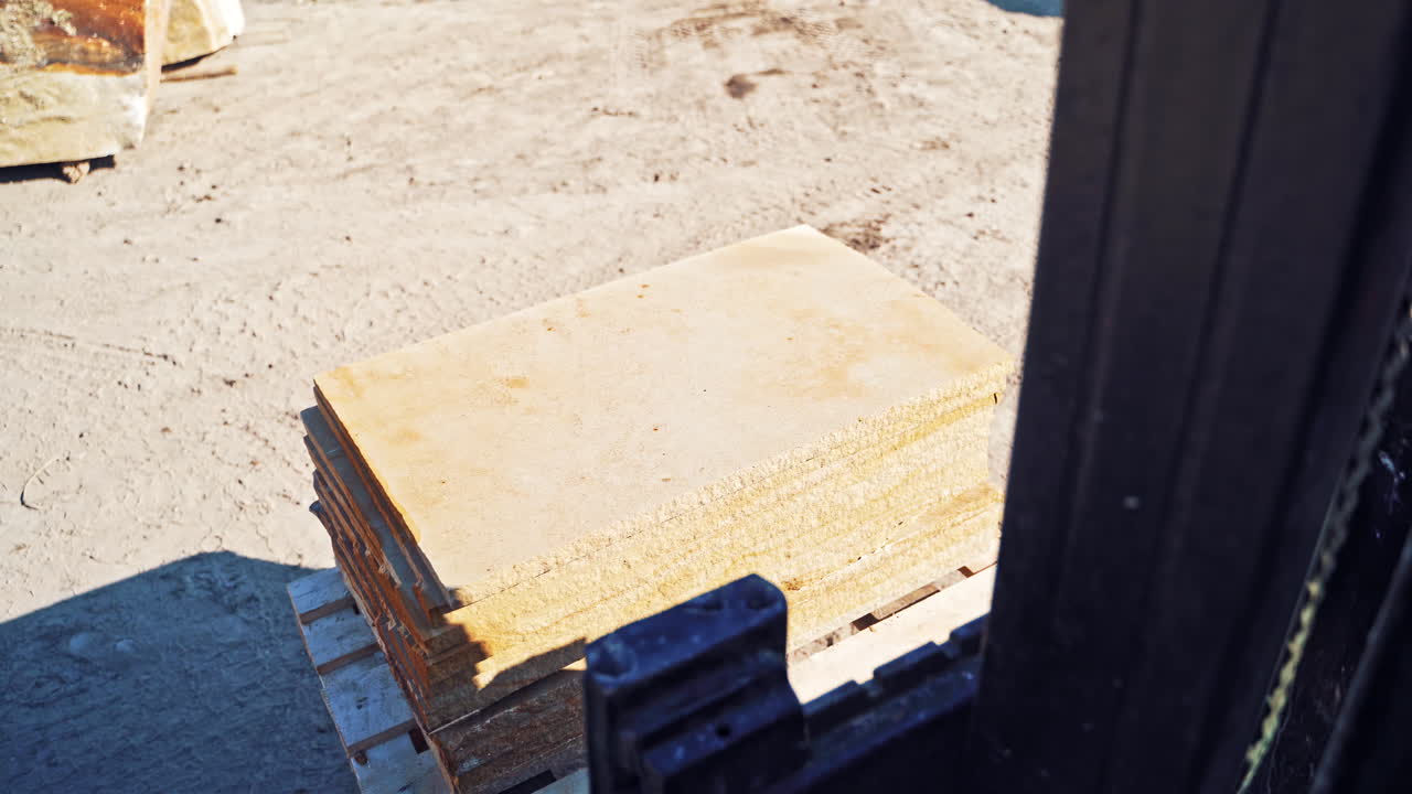 Forklift at marble area. Close up view of forklift loader forks