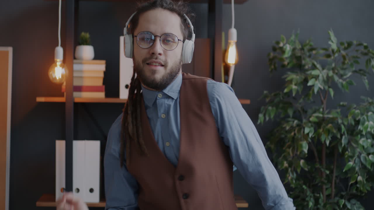 Man Dancing in Office with Headphones