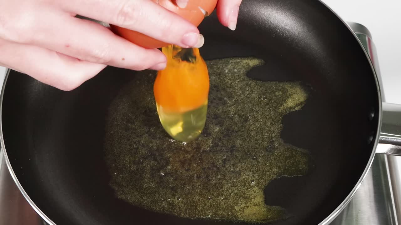 Sequential frames showing an egg being fried
