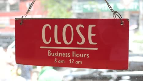 closed sign hanging on door of cafe