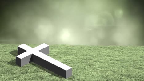 animation of grey christian cross lying on field of grass with glowing green clouds