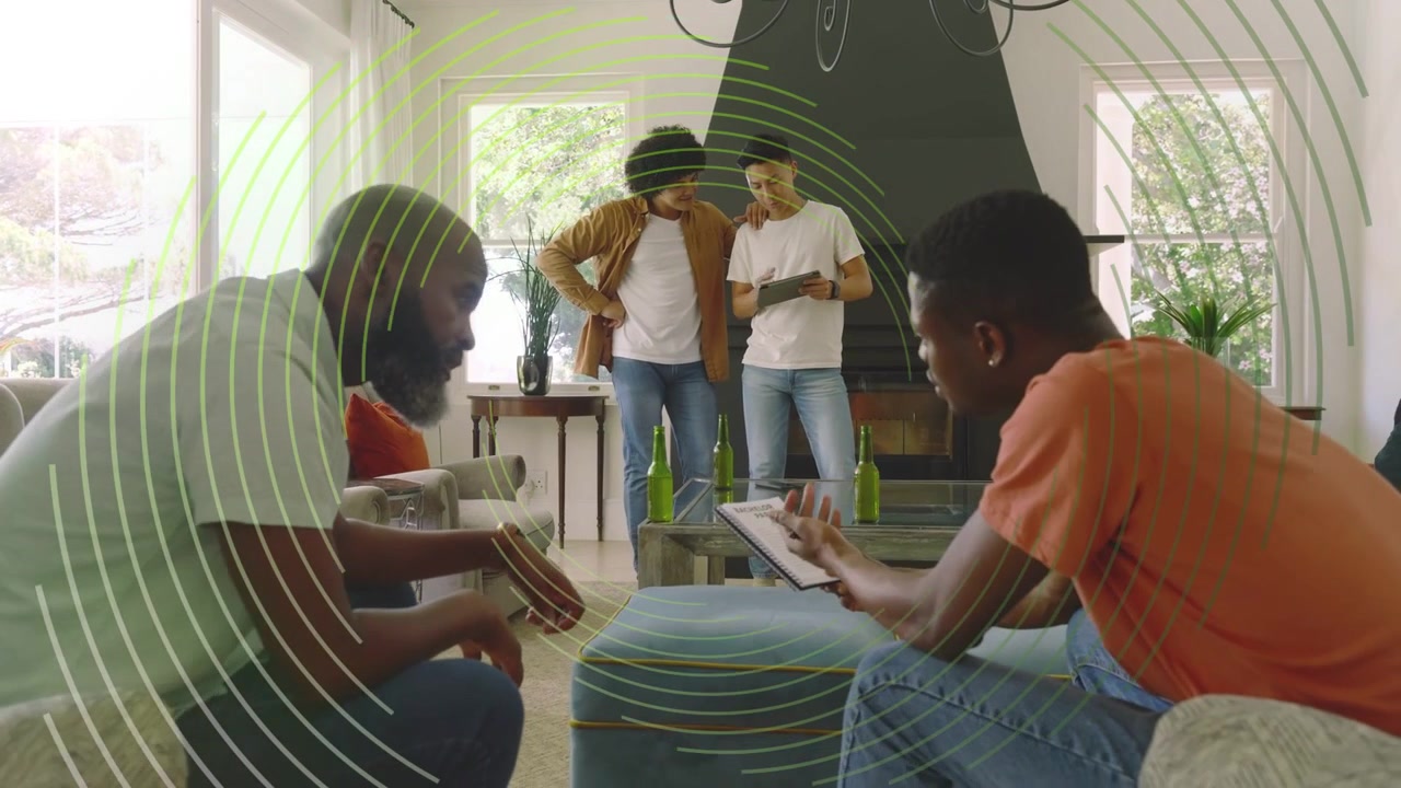 Four men leaning in, one pointing tablet while seated duo passing booklet, circles aiding marketing