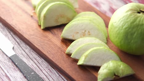 sliced guava on a wooden cutting board