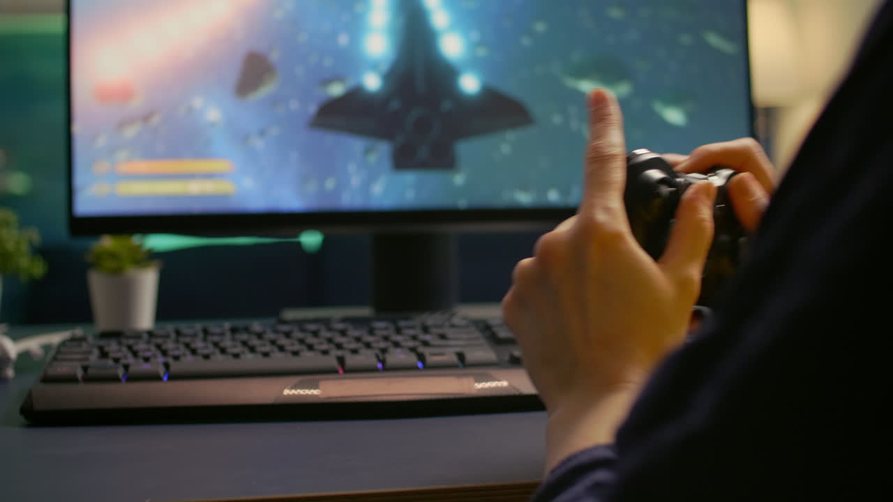 Close-up of professional cyber gamer playing space shooter video game