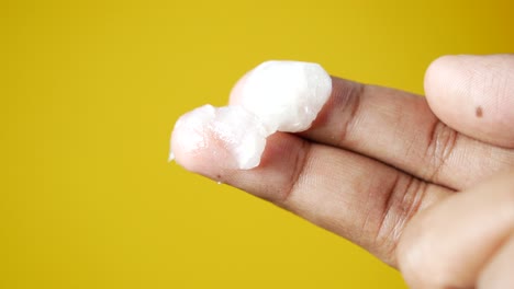 close-up of white cream on a finger