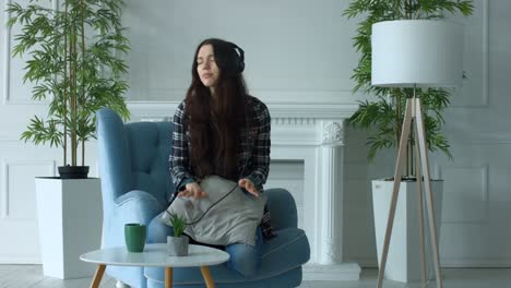 joyful young woman in headphones enjoying music