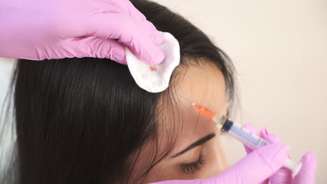 needle mesotherapy. cosmetologist makes injections into the scalp. thrust to strengthen hair and their growth