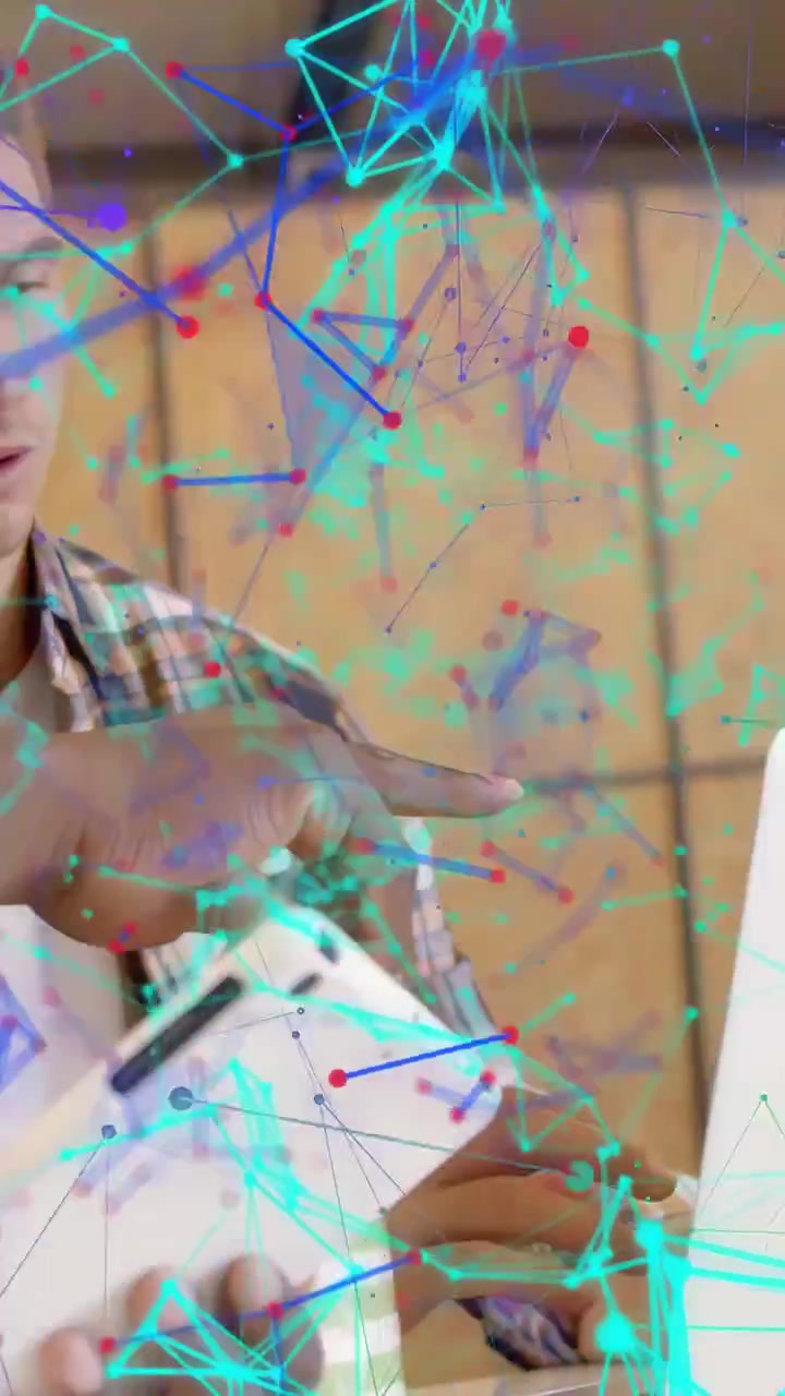 Vertical video: Hand lifting laptop, man using phone as peer pointing, nodes overlaying view for UX