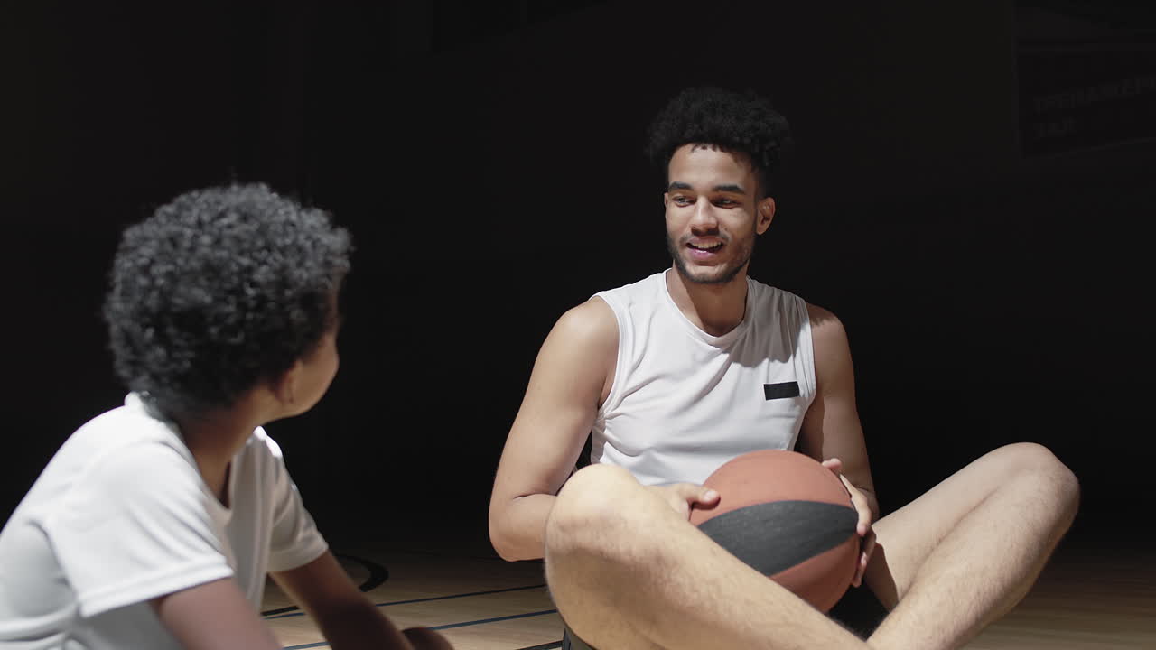 Slowmo of Basketball Player Talking to Kid