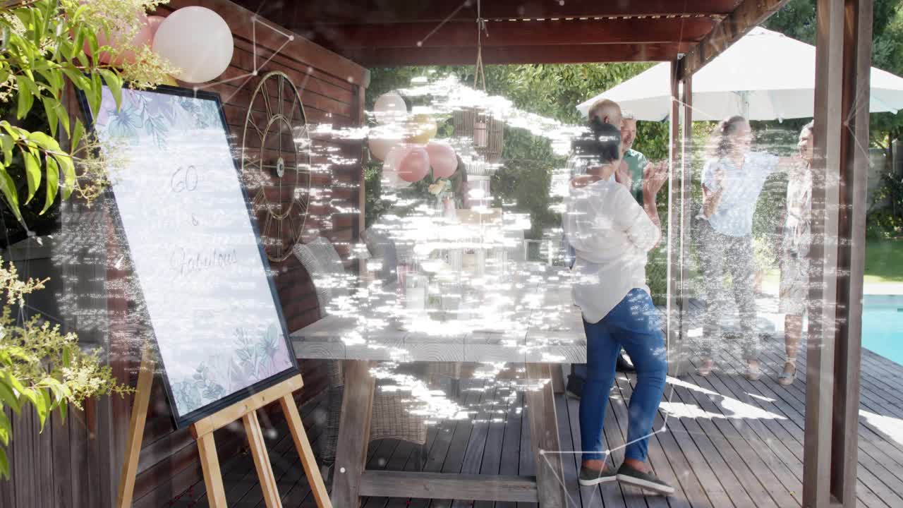 Mature woman leaving easel, waving to arriving guests for milestone while padlock overlay appearing