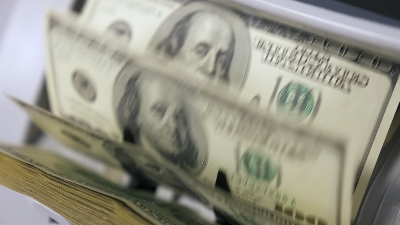 Portrait of President Benjamin Franklin for 100 American dollars cash money. Money counting equipment for paper money calculation. Automatic mechanism for bank financial operations.