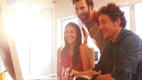 Graphic-designers-having-discussion-on-computer-monitor