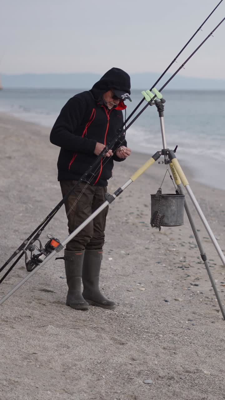 Fisherman on the beach with fishing rod