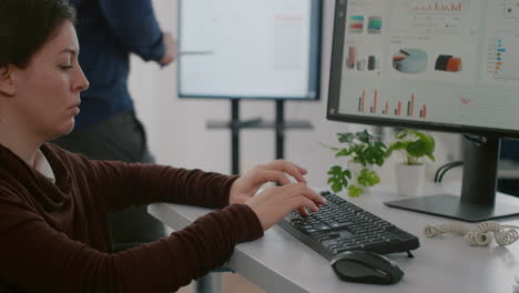 Handicapped-worker-analysing-financial-statistics-typing-on-computer