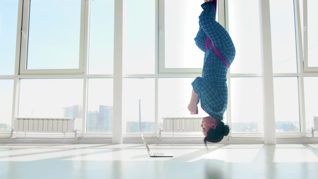 Woman in Inversion Yoga Pose with Laptop