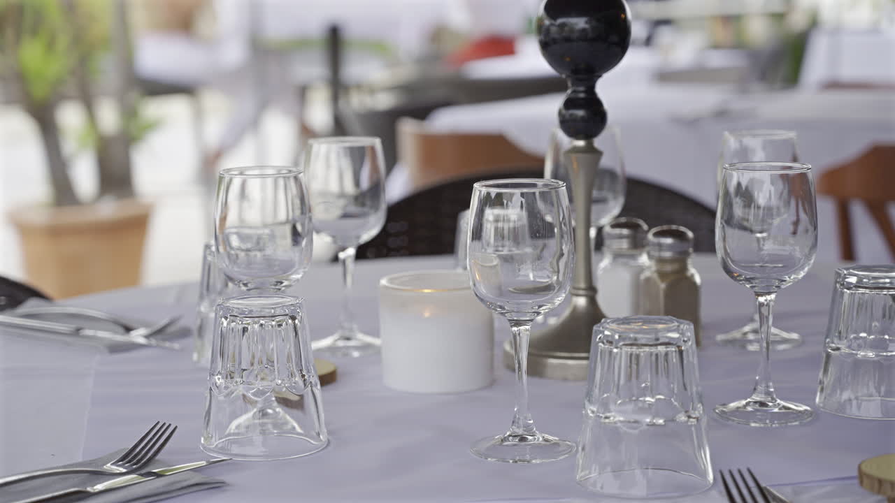Close up of glasses on a set table at a terrace with a blurred background