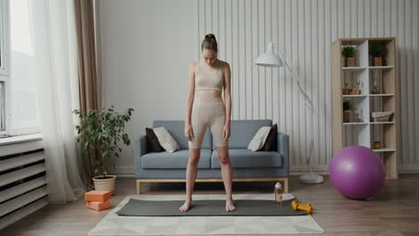 young woman practicing yoga at home