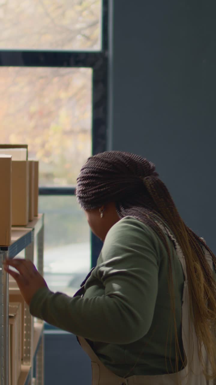 Vertical video Supervisor in warehouse handling boxes