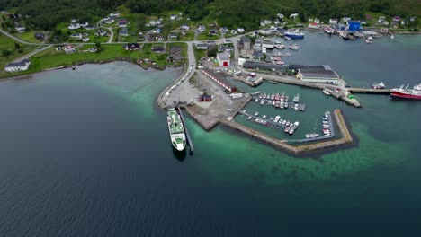 Flying-towards-Botnhamn-ferry-port-during-summer-season-with-a-long-queue-of-cars-and-campers