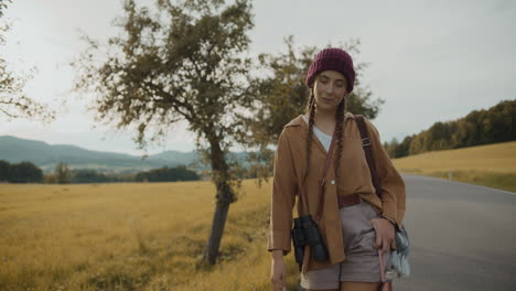 female tourist with knitted hat while walking on road