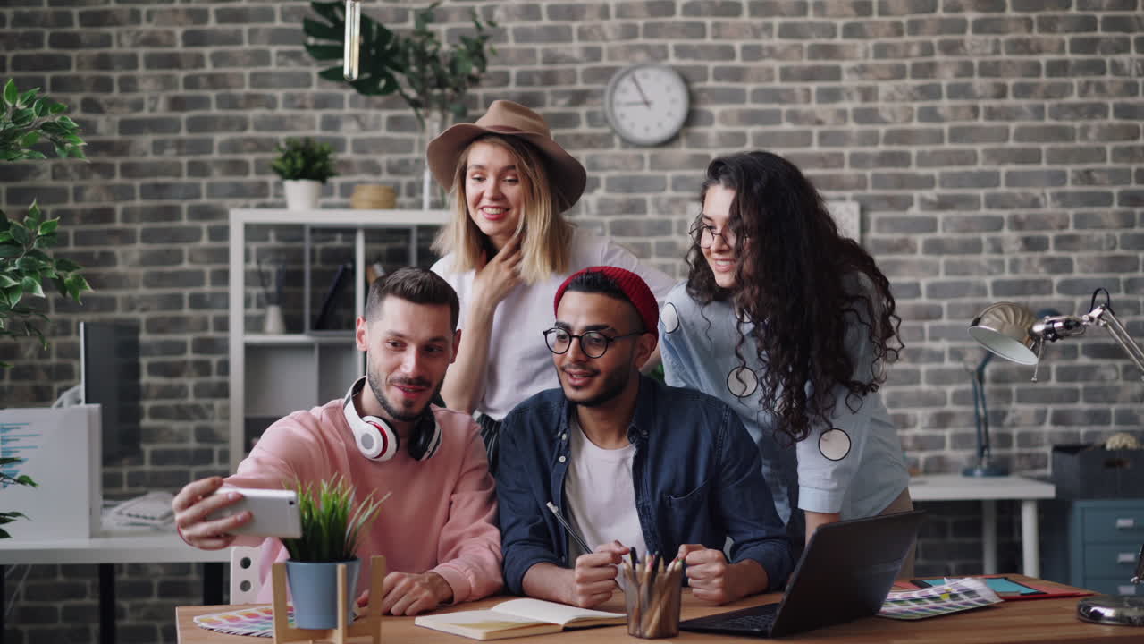 Happy team taking a selfie in a modern office