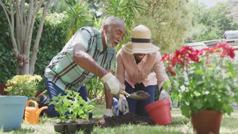 father and daughter gardening during a sunny day