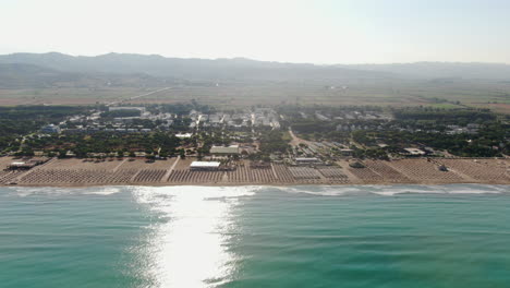 Albanian-Riviera-Beaches:-fantastic-aerial-view-with-lateral-movement-from-the-sea-towards-the-shore-of-the-beach-on-a-sunny-day