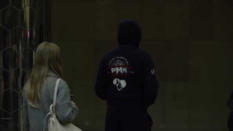 person wearing boxing jacket in an underground station