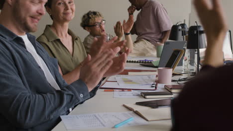 business colleagues applauding at a successful meeting