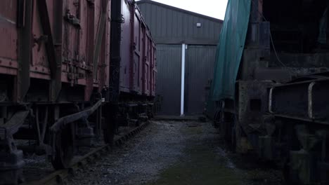 stationary wooden cargo train carriages wide panning shot