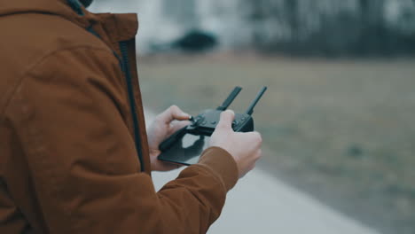 young man flying a drone outside-2